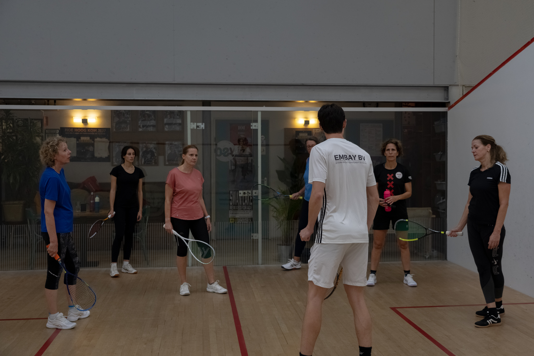 Coach leading a group lesson on court